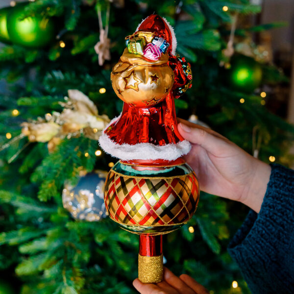 Santa claus in checkered outfit tree top 1k0a7484